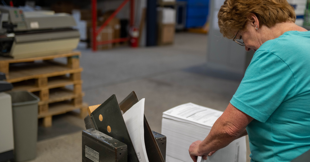 Image of a woman working in a local print shop